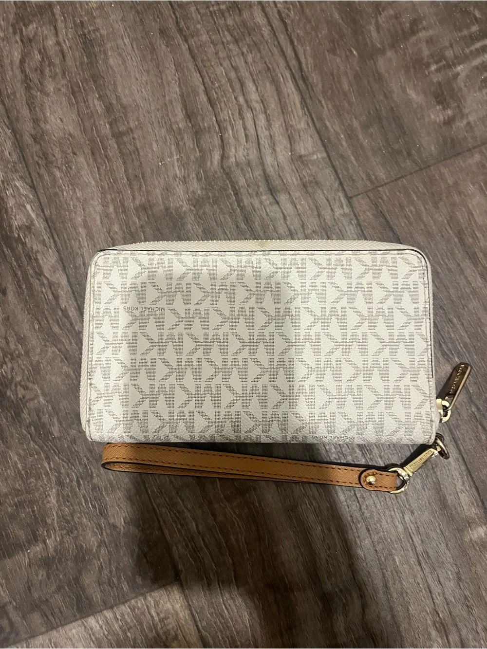 Michael Kors white and tan wallet, pealing on sides shown in photos